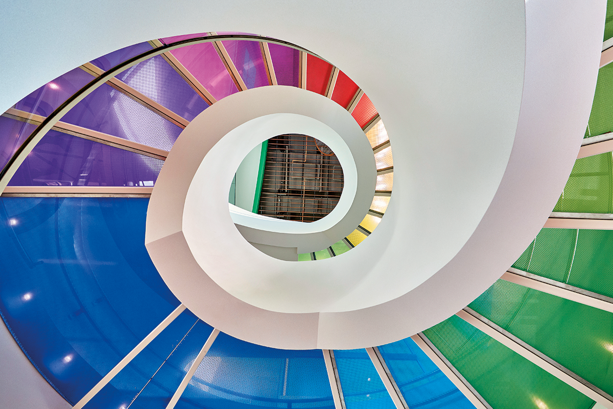 spiral glass stairway with rainbow colored steps