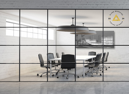 an interior photo looking through a glass partiion to a conference room with table, chairs and large monitor mountted on the wall