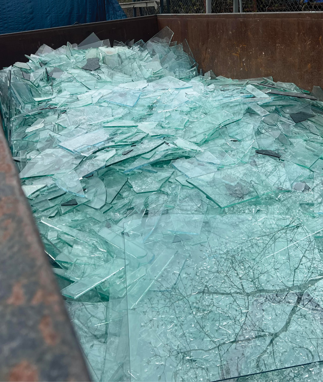 dumpster filled with broken glass